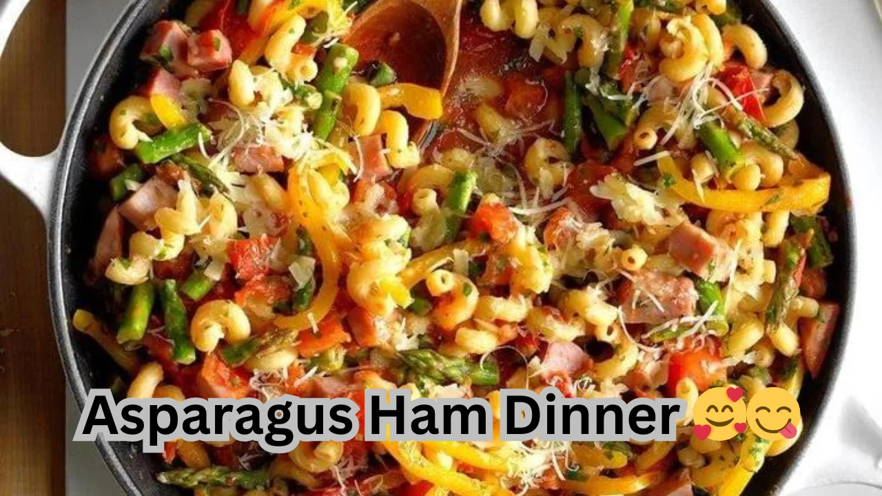 A plate of asparagus and ham dinner served with pasta and assorted vegetables, showcasing a colorful and appetizing meal.