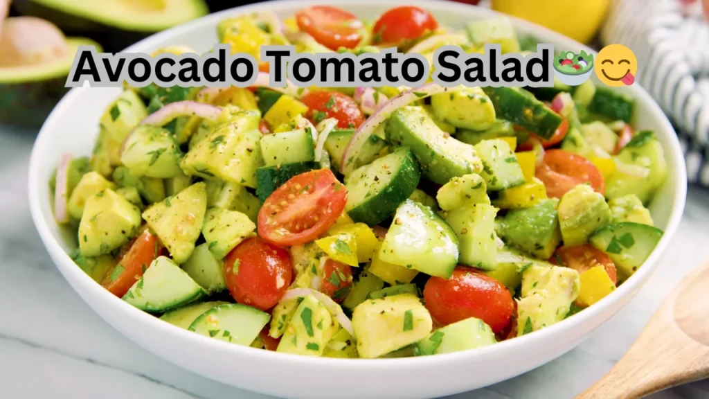 A colorful salad made with sliced avocados and tomatoes, garnished with herbs, served in a white bowl.