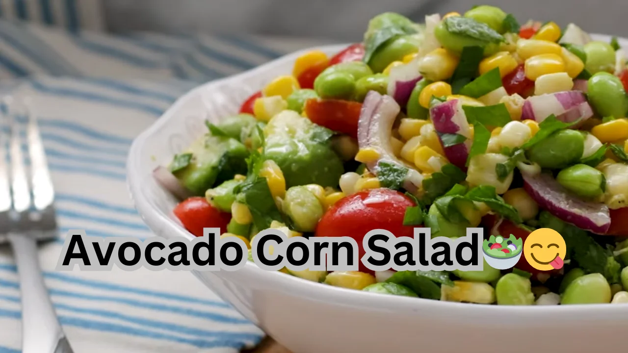 A delicious avocado corn salad with diced tomatoes, corn kernels, and cucumber slices, all mixed together in a bowl.