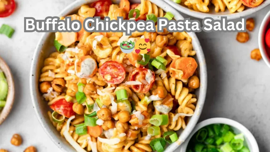 A vibrant bowl of buffalo chickpea pasta salad, featuring pasta, chickpeas, celery, and a spicy buffalo sauce dressing.