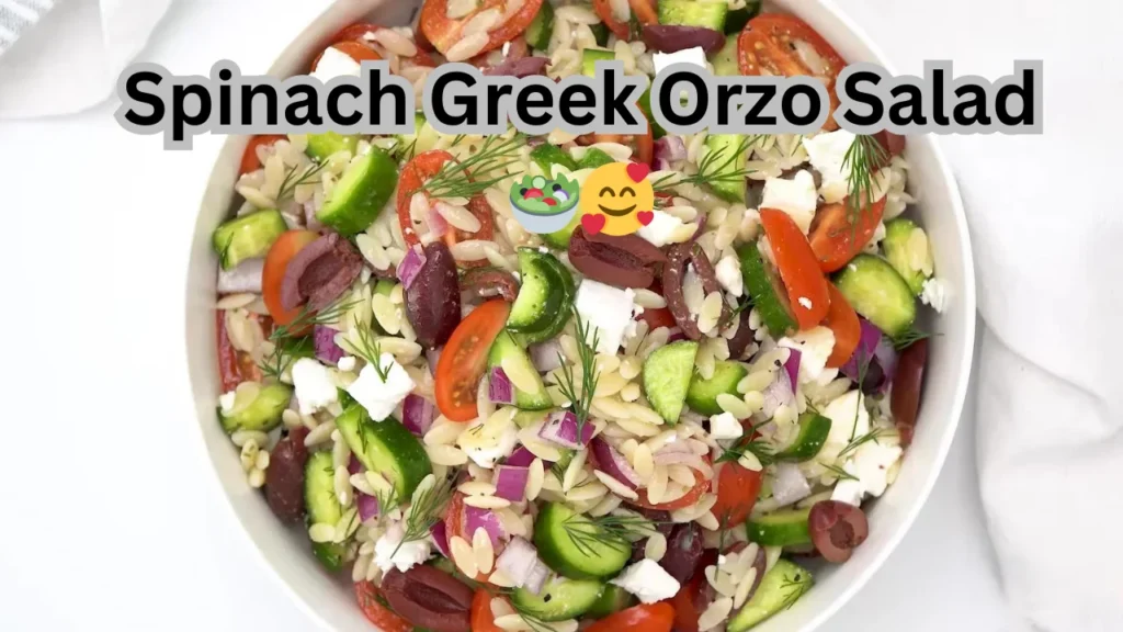 A delicious Spinach Greek Orzo Salad showcasing fresh spinach, diced tomatoes, olives, and feta cheese, beautifully arranged.