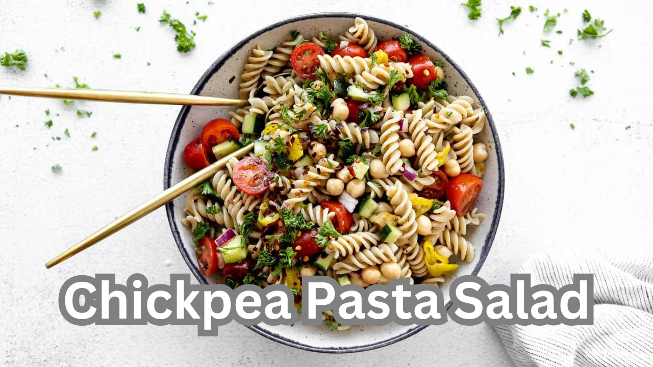 A delicious chickpea pasta salad filled with colorful vegetables and herbs, presented in a bowl, ideal for a nutritious dish.