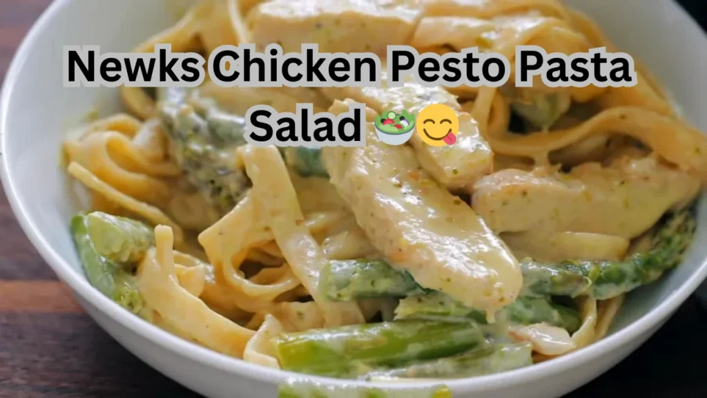 A delicious chicken pesto pasta salad, showcasing pasta, grilled chicken, and fresh vegetables, presented in a dish.
