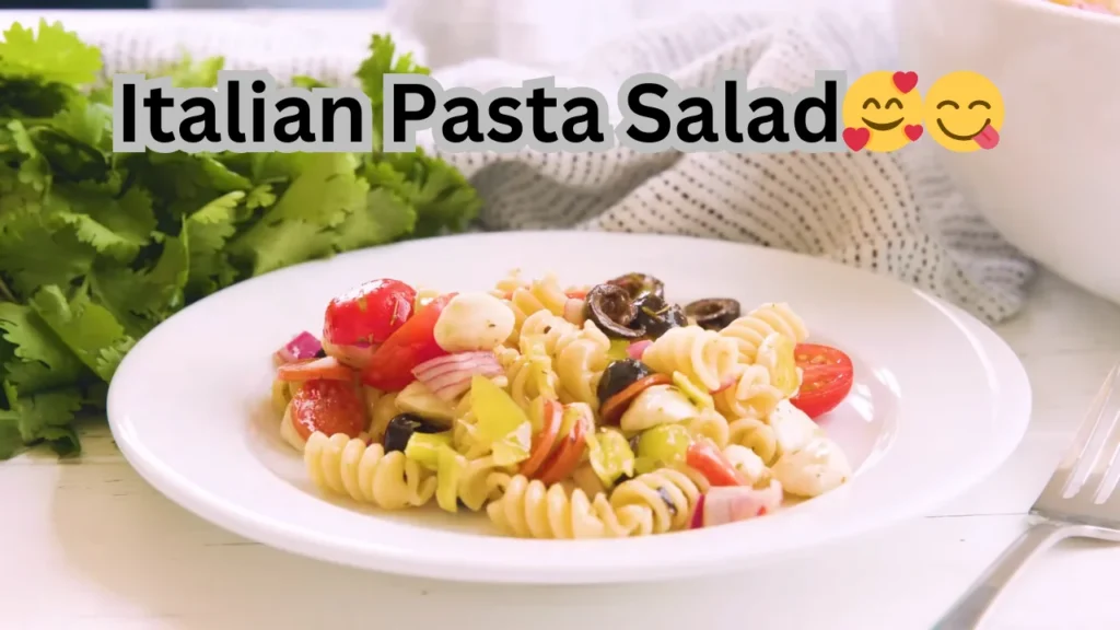 Delicious Italian pasta salad with fresh tomatoes, olives, and feta cheese, beautifully arranged in a bowl.