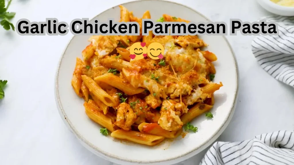 A delicious bowl of garlic chicken parmesan pasta, garnished with fresh herbs and melted cheese, ready to enjoy.