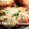 A delicious baked chicken parmesan topped with cheese and sauce, garnished with herbs, ready to be served.