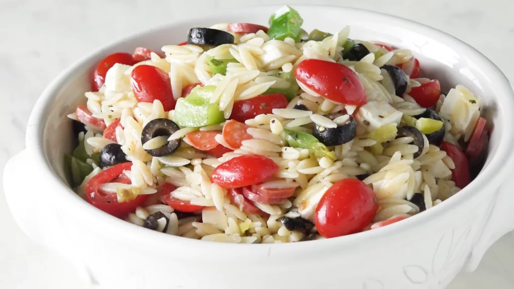 Summer Pasta Salad 2 A delicious bowl of summer pasta salad filled with juicy tomatoes, savory olives, and hearty black beans.