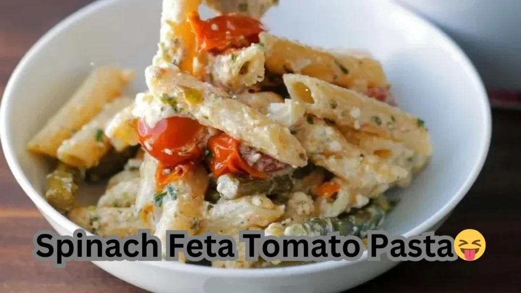 Spinach feta tomato pasta served in a bowl, showcasing vibrant colors and fresh ingredients.